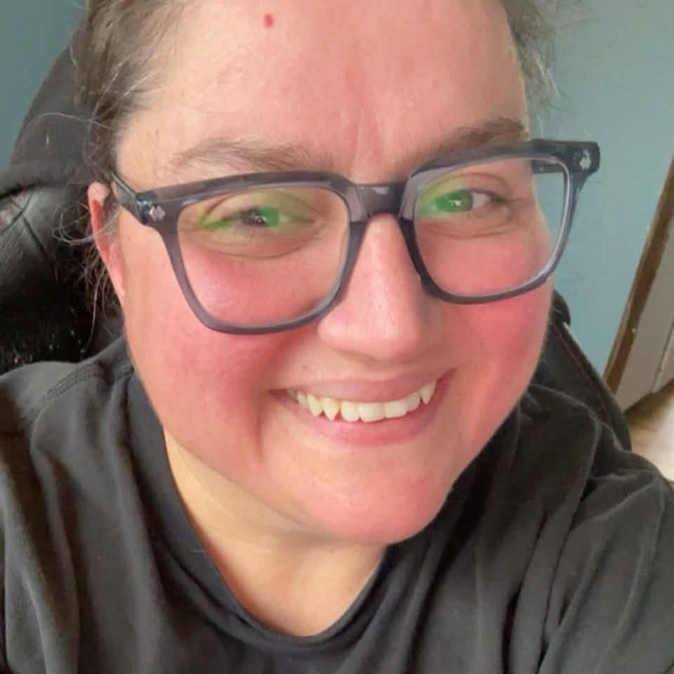 Portrait of Solange Bezeau smiling and wearing glasses